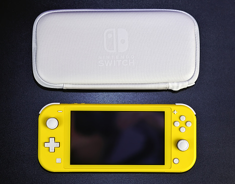 MOSCOW, RUSSIA - October 08, 2019: Nintendo Switch Lite is Nintendo's latest entry into handheld gaming. Priced at $199.99, the Switch Lite is available in yellow color