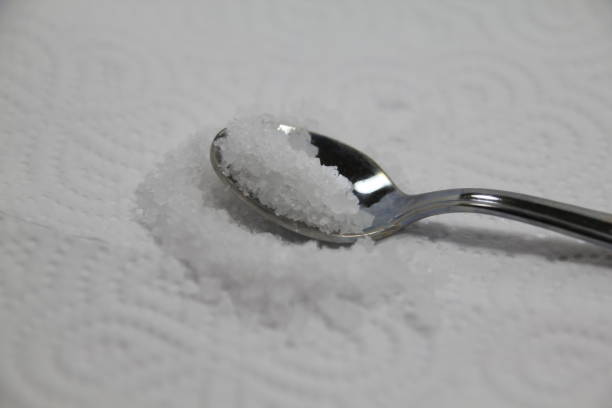 istock salt in a spoon on a white background 1196550349