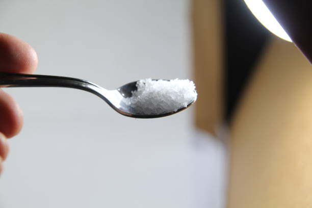 istock salt in a spoon on a white background 1196550382