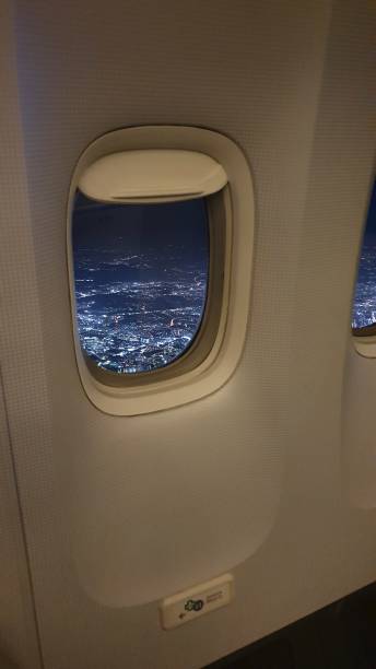 istock airport window inside airplane above the night sky 1196554986
