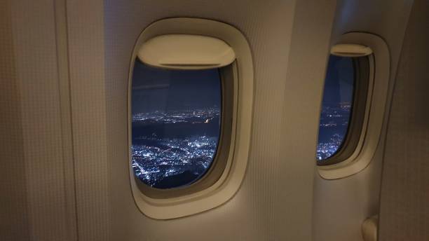 istock airport window inside airplane above the night sky 1196555001