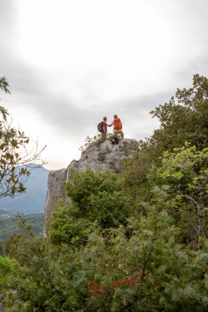 istock Father and son pause on hike at edge of vertical cliff 1196559099
