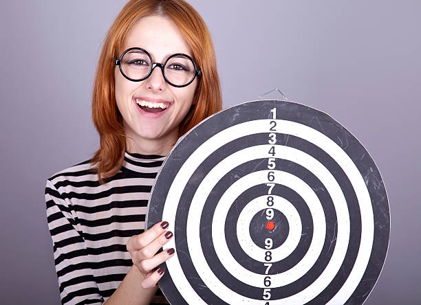istock Red-haired girl with dartboard. 119656314