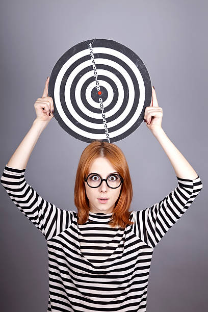 istock Red-haired girl with dartboard. 119656390