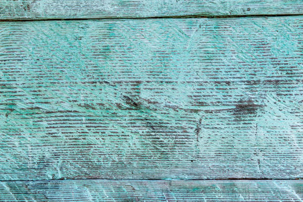 Old weathered wood plank painted in blue.