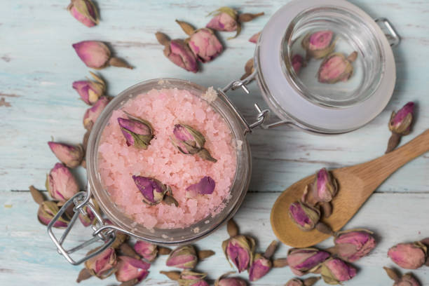 Homemade and natural spa of rose bath salts Homemade spa of rose bath salts on a light wooden background. Cosmetics and natural medicine bath salt photos stock pictures, royalty-free photos & images