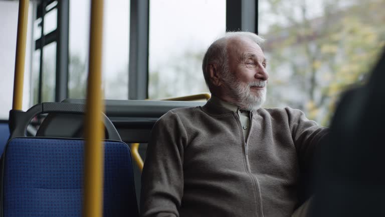 Smiling senior man riding on a bus