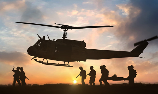 Helicóptero de rescate militar durante la puesta del sol photo