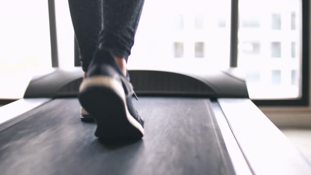 Leg of woman running on treadmill