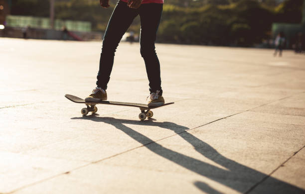 istock Skateboarder skateboarding at sunset city 1196587008