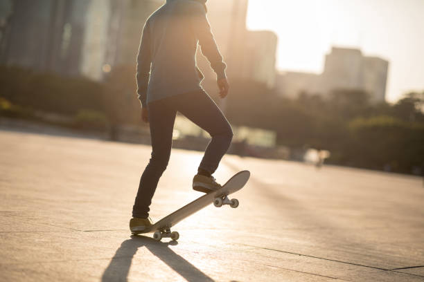 istock Skateboarder skateboarding at sunset city 1196587164