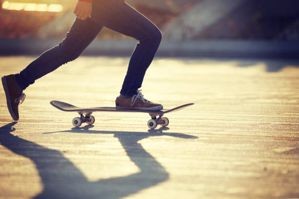 istock Skateboarder skateboarding at sunrise city 1196589470