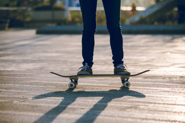 istock Skateboarder skateboarding at sunrise city 1196589482