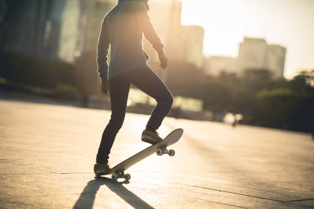 istock Skateboarder skateboarding at sunset city 1196589639