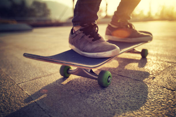 istock Skateboarder skateboarding at sunrise city 1196589661