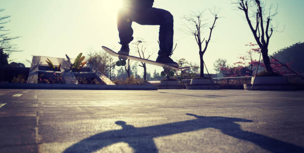 istock Skateboarder skateboarding at sunrise city 1196589678