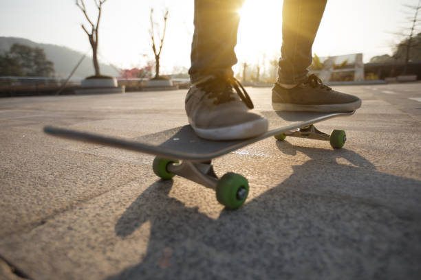 istock Skateboarder skateboarding at sunrise city 1196589751
