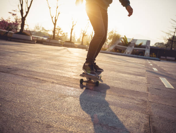 istock Skateboarder skateboarding at sunrise city 1196590295
