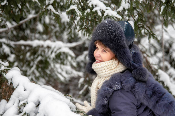 istock Woman in a snowy forest 1196596133