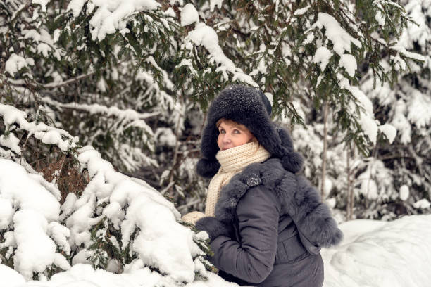 istock Woman in a snowy forest 1196596135