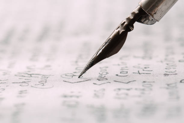 istock fountain pen on paper with ink text closeup 1196596909
