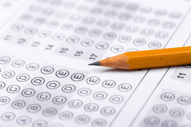 istock testing in exercise and exam paper. computer sheet with pencil in school test room, education concept 1196597140