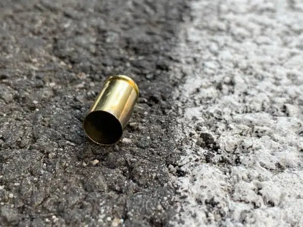 Bullet casing on asphalt