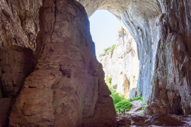 istock Prohodna cave, climbing on the eyes 1196600359