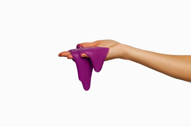 istock Violet slime in hand, isolated on white. 1196600433