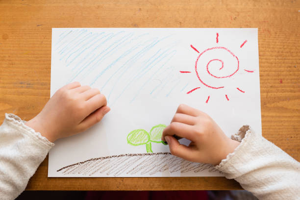 istock Hand of a child who draws 1196605808