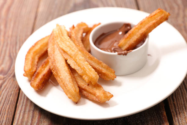 istock fried churros and chocolate sauce 1196606892