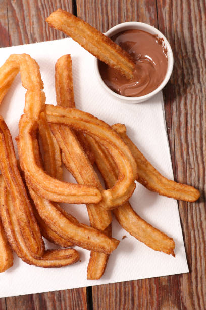istock fried churros and chocolate sauce 1196607401