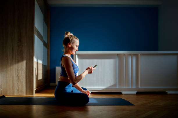 istock Woman using smartphone at home 1196608537