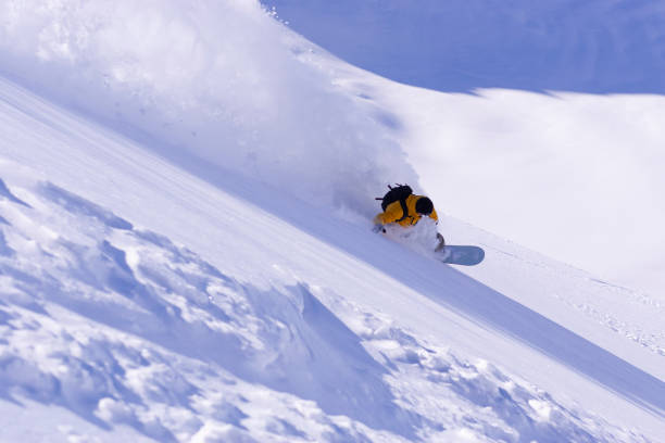 istock Snowboarder doing a high speed turn in powder snow 1196617636
