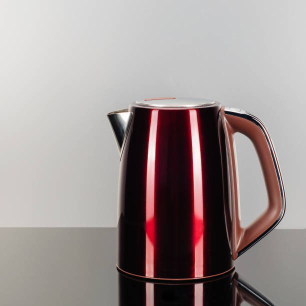 istock Red stainless steel kettle on the grey mirror background 1196618170