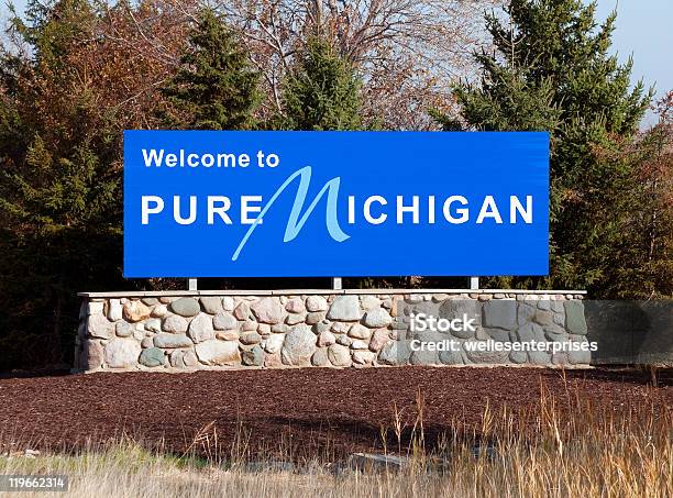 Blue Welcome To Pure Michigan Sign On A Stone Wall Stock Photo - Download Image Now - Michigan, Welcome Sign, Sign