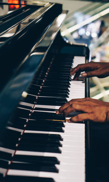 istock Close Up of Hand Playing Piano 1196624574