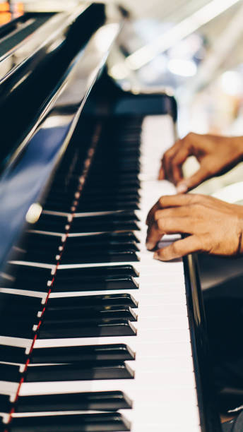 istock Close Up of Hand Playing Piano 1196624612