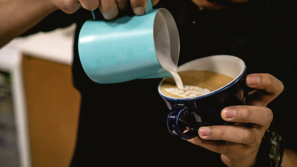 istock Barista Drawing on Coffee and Making Latte 1196624660