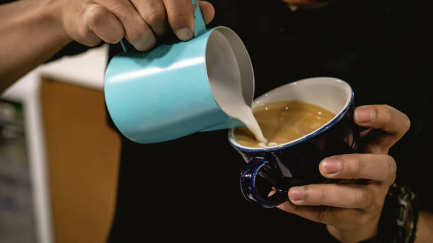 istock Barista Drawing on Coffee and Making Latte 1196624726