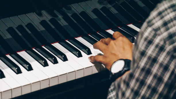 istock Close Up of Hand Playing Piano 1196624797