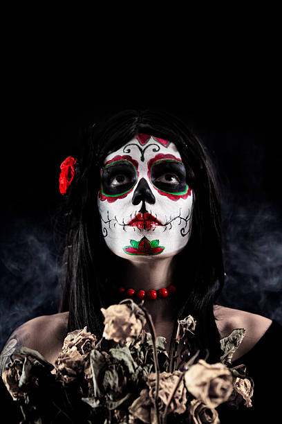 istock Sugar skull girl with dead roses 119662565