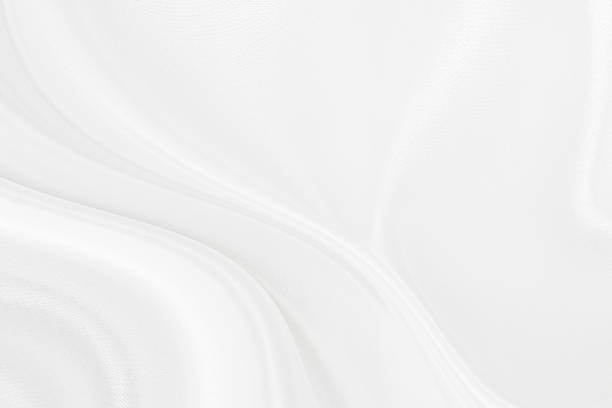 istock White gray satin texture that is white silver fabric silk background with beautiful soft blur pattern natural. 1196627396