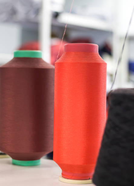 istock bobbins with elastic yarn on a knitting machine in the shop 1196628484
