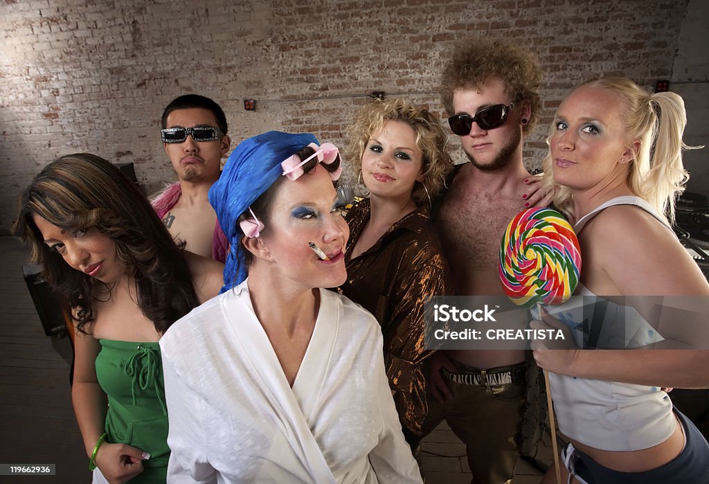 Eccentric woman hanging out with party kids  1970-1979 Stock Photo