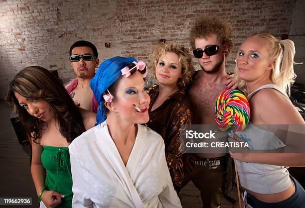 Eccentric Woman Hanging Out With Party Kids Stock Photo - Download Image Now - 1970-1979, Cigarette, Eccentric