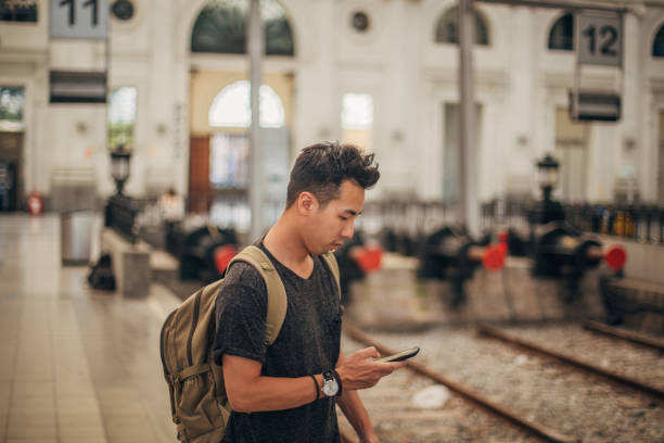 istock Young man on the railway station 1196631689