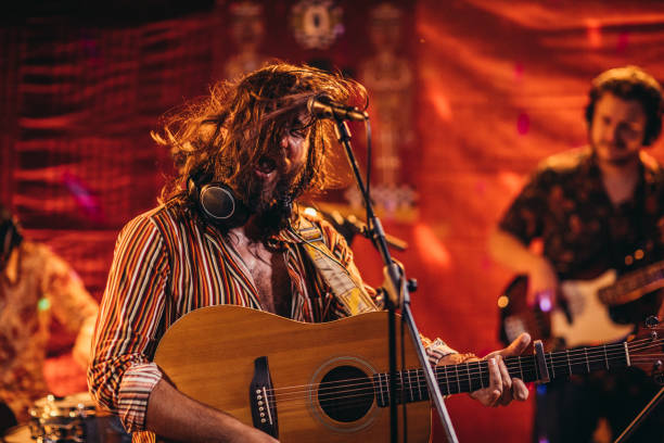 istock Man musician performing on stage with band 1196633993