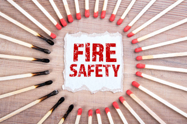 Fire Safety. Smoke detectors, alarms, extinguishing systems and knowledge concept Fire Safety. Smoke detectors, alarms, extinguishing systems and knowledge concept. Burned matches on wood texture background fire inspection stock pictures, royalty-free photos & images