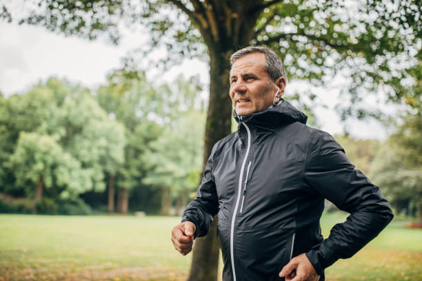 istock Mature gentleman jogging alone in park 1196637706